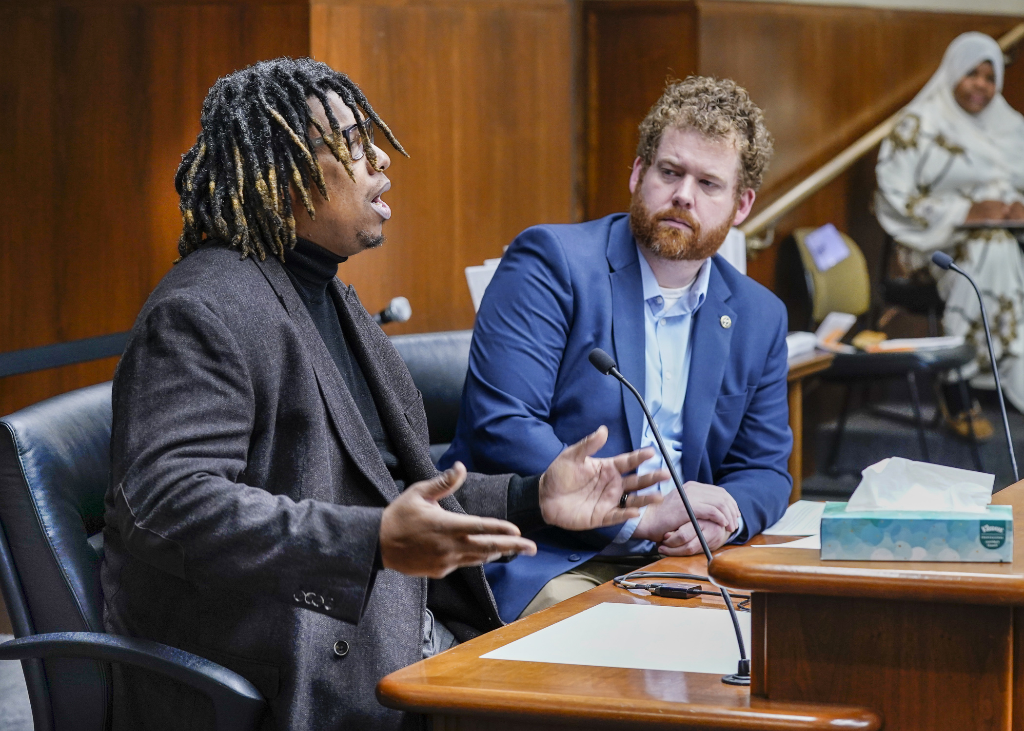 Walter Dillon, former owner of KKG Kickz, testifies before the House public safety committee Feb. 7 in support of a bill to establish the crime of organized retail theft. Rep. Zack Stephenson, right, sponsors HF450. (Photo by Catherine Davis)